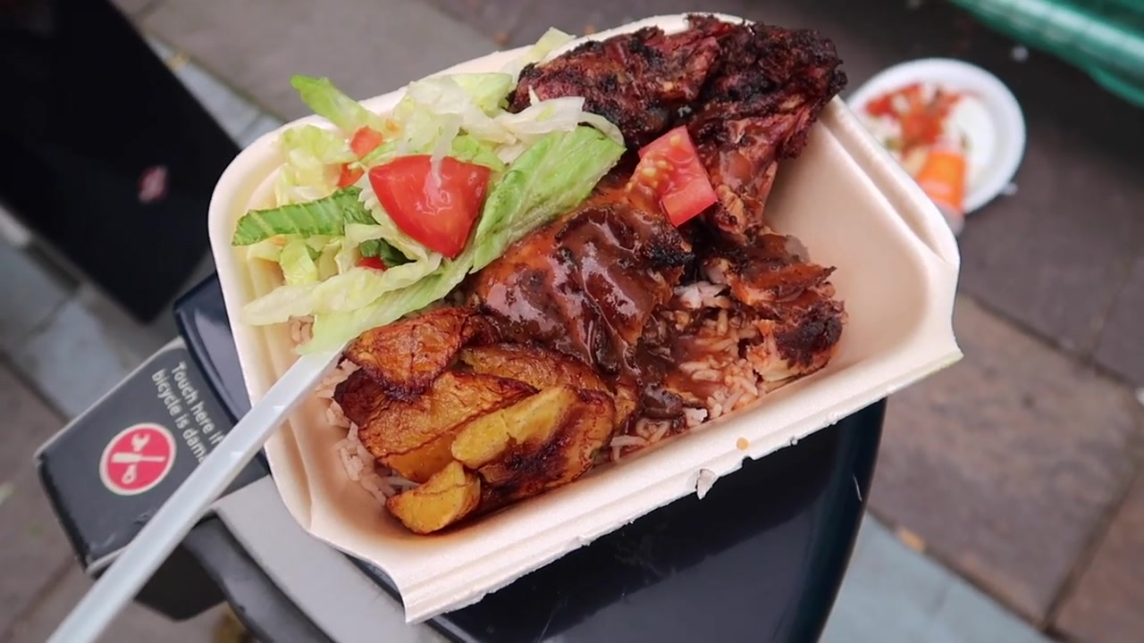 Jerk chicken with rice and peas, plantain and salad