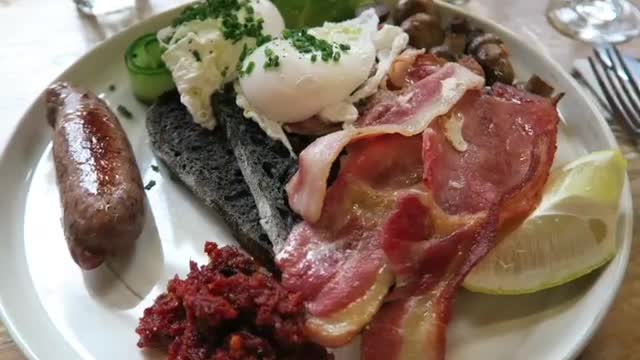 Bondi breakfast with poached eggs, bacon, sausage and charcoal sourdough