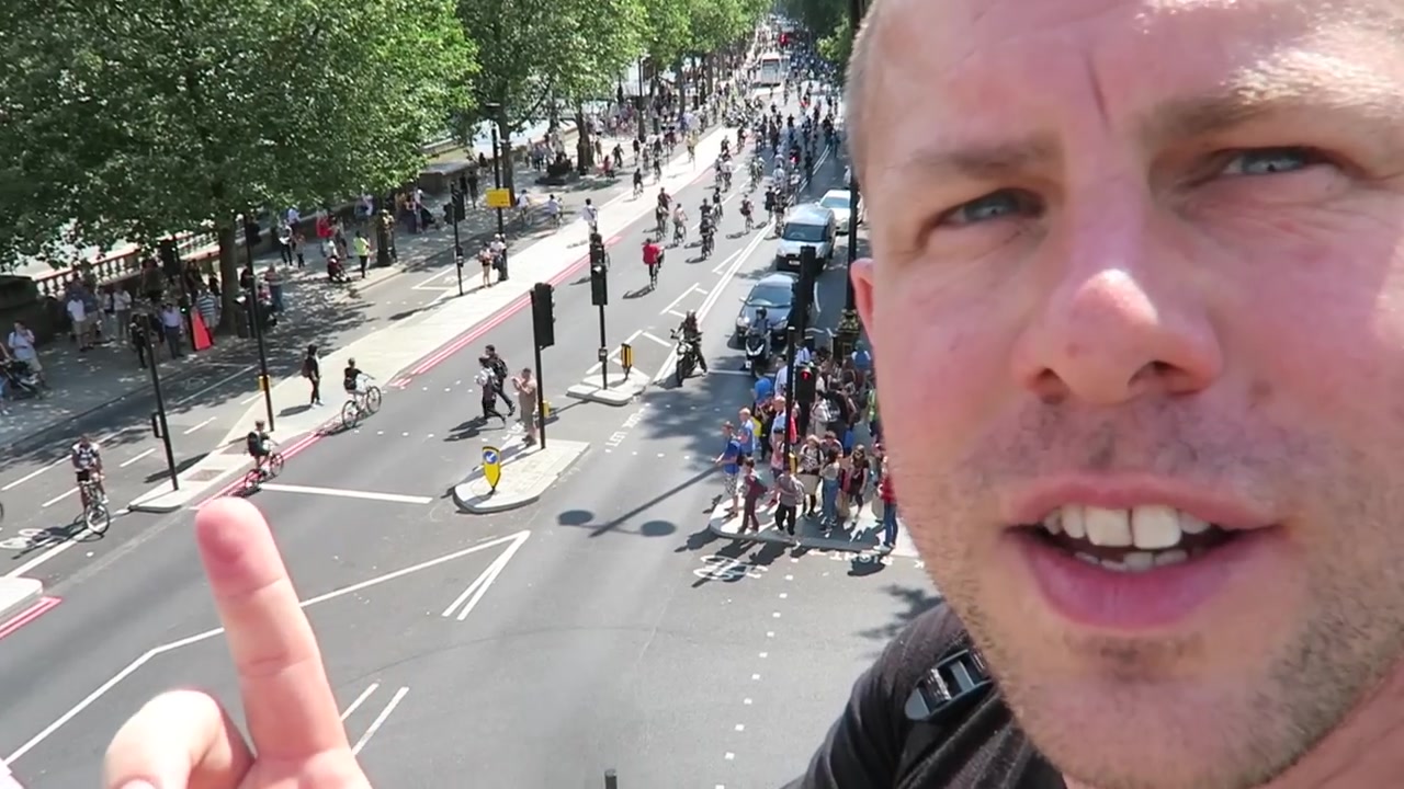 Barry Roberts filming with the BikeStormz rideout on the Embankment behind him