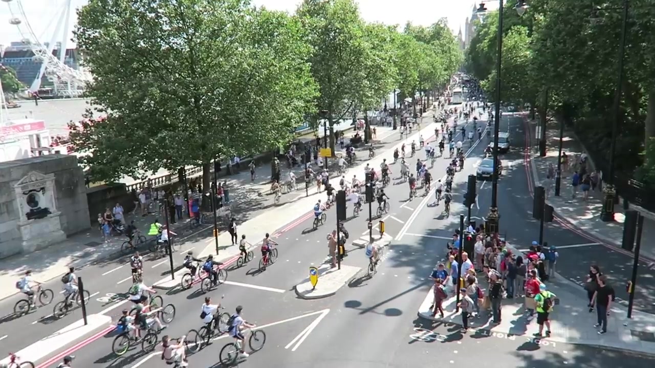 Groups of BikeStormz cyclists passing below the camera on Victoria Embankment