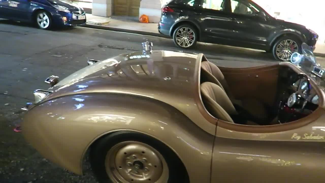 Open-top classic car parked outside Belstaff during the 2016 evening walk