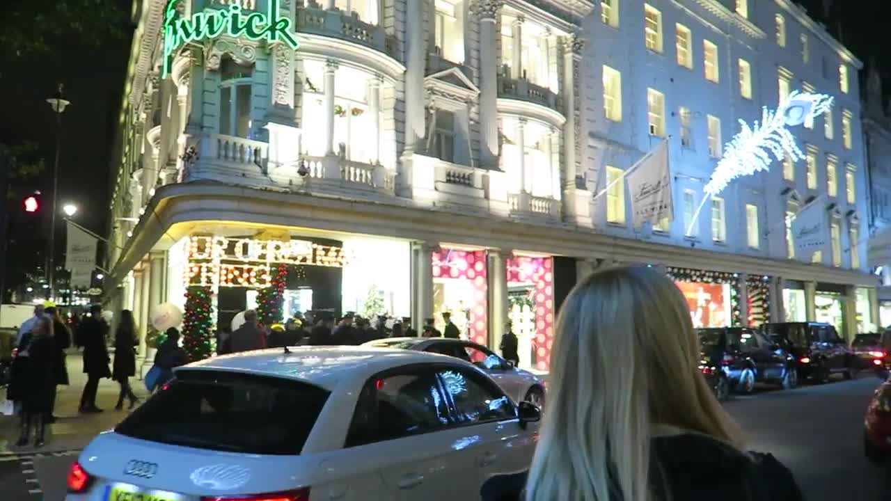 Fenwick department store on Bond Street with festive windows and night traffic