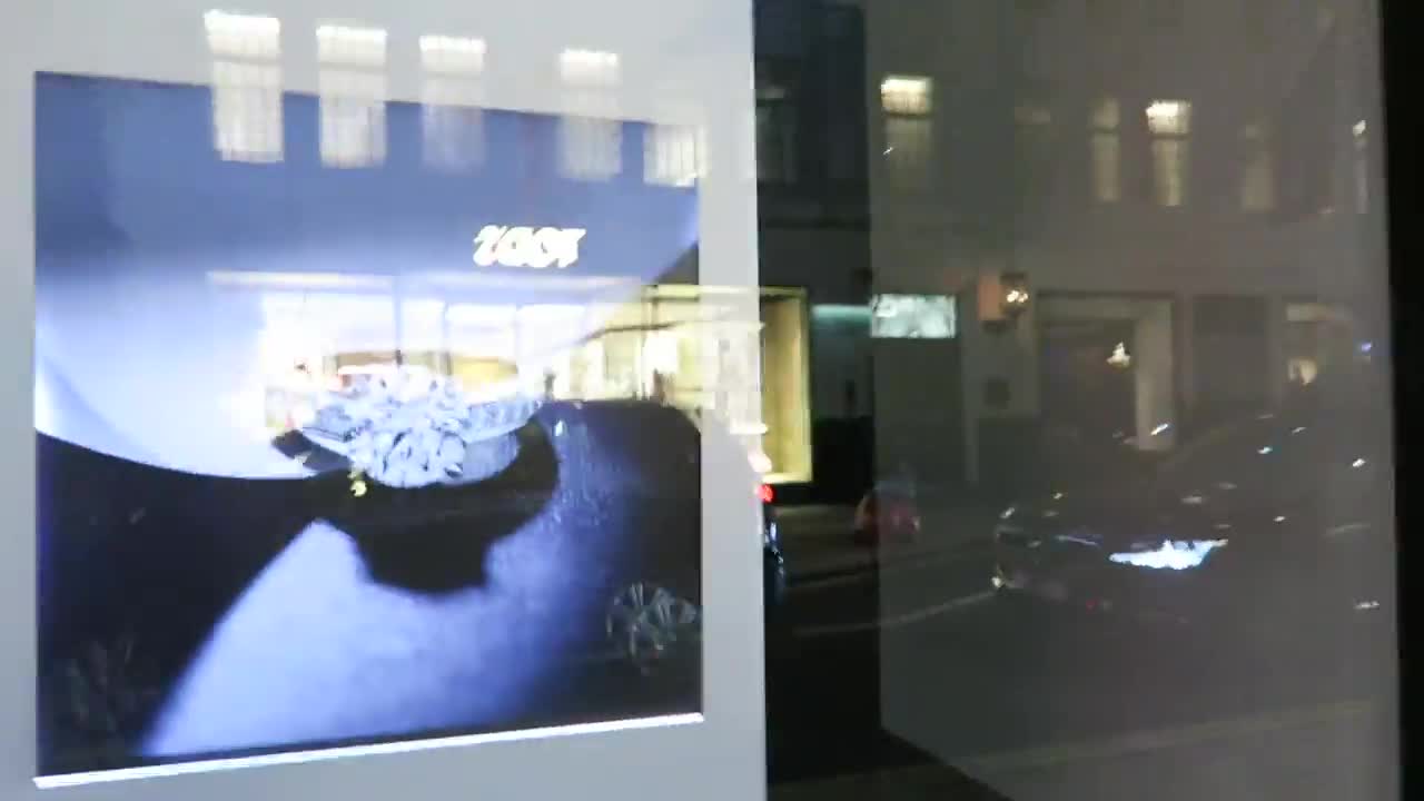 Illuminated jewellery display seen through a shop window on Old Bond Street