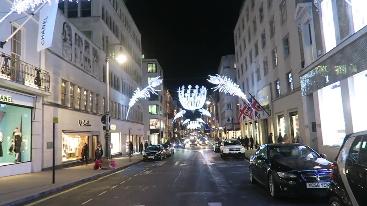 Christmas lights above New Bond Street with illuminated shops and cars