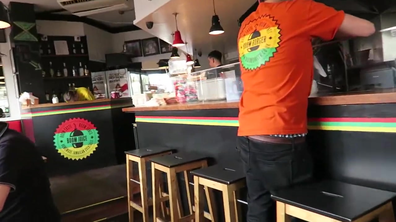Counter and wooden stools inside Boom Burger on Portobello Road