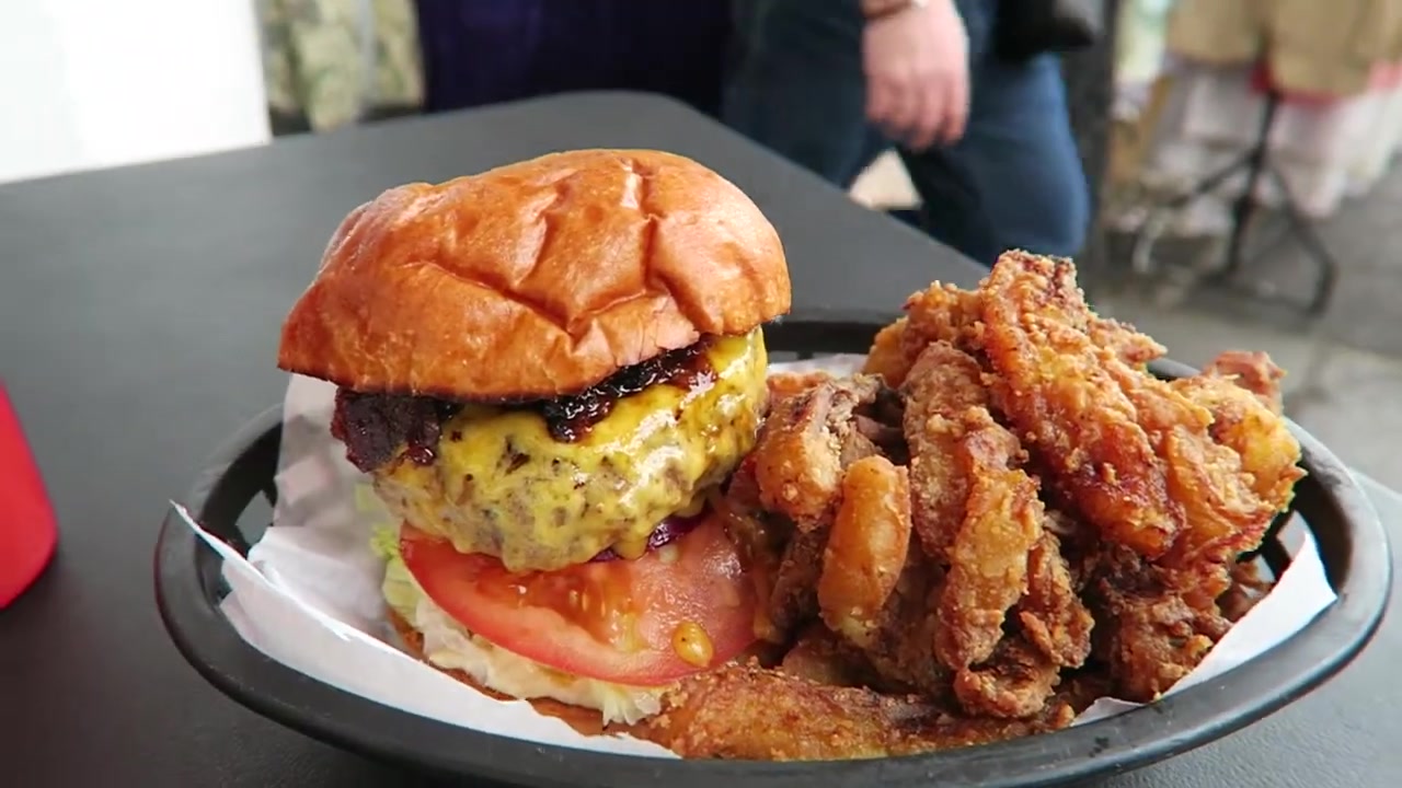Burger and crisp plantain strips served together on a tray