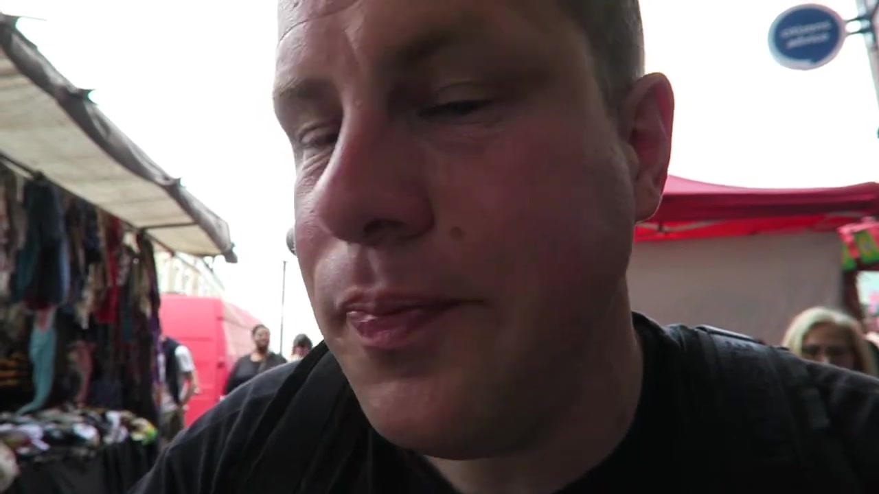 Barry tasting the food beside the Portobello Road market stalls