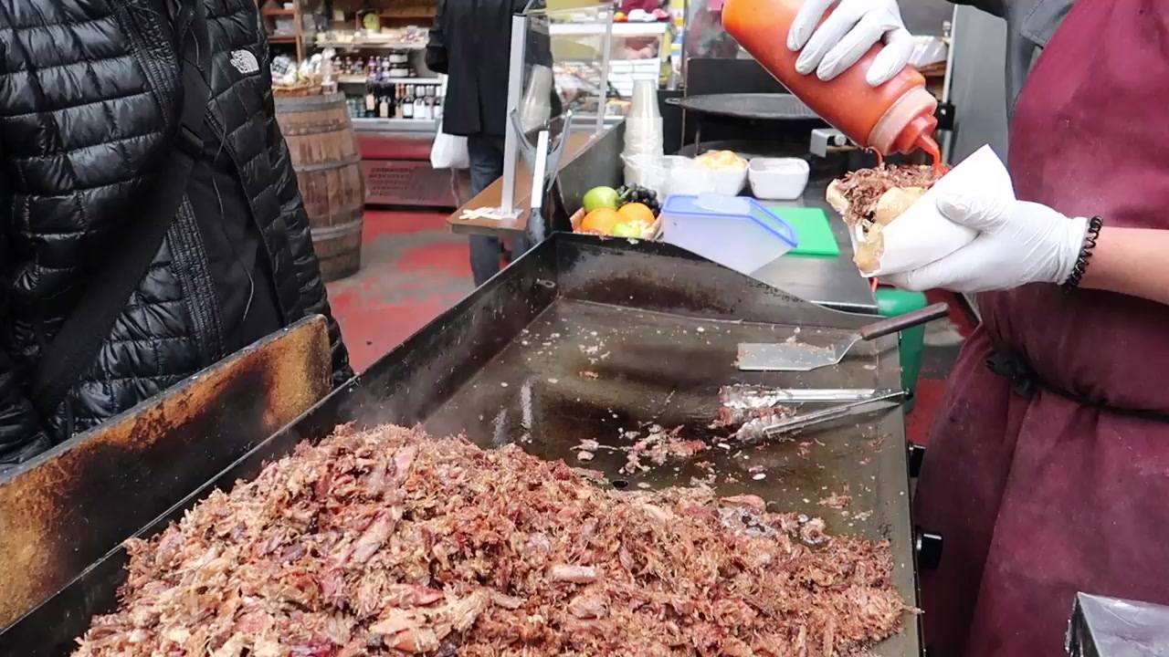 Duck being prepared on the hotplate for a market sandwich.