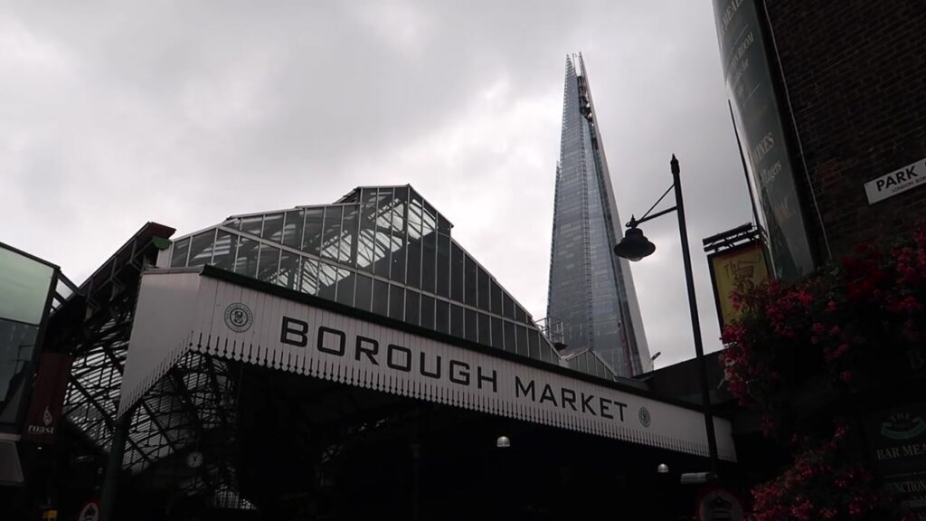 Borough Market’s entrance with the Shard rising behind it.