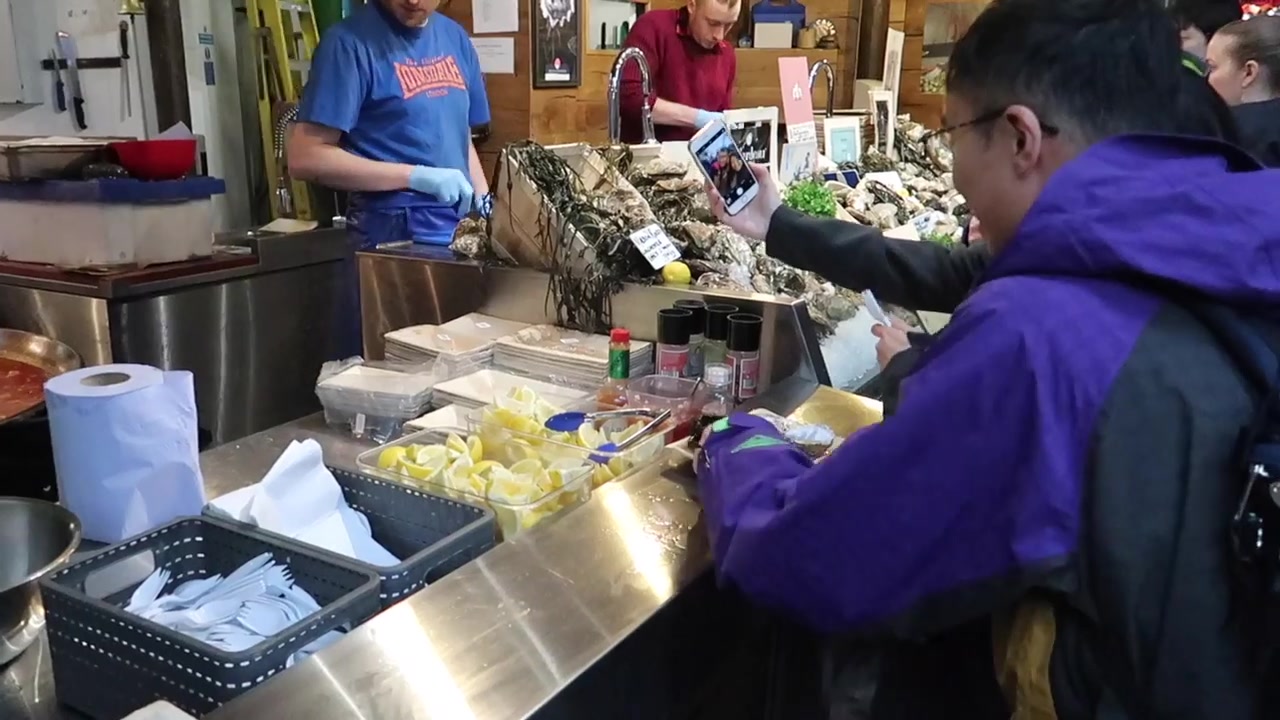 Food traders preparing orders at a Borough Market counter