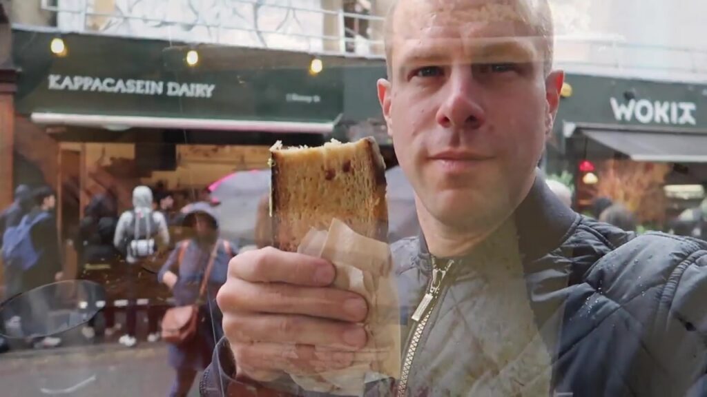 Barry Roberts holding a toasted cheese sandwich outside Kappacasein Dairy