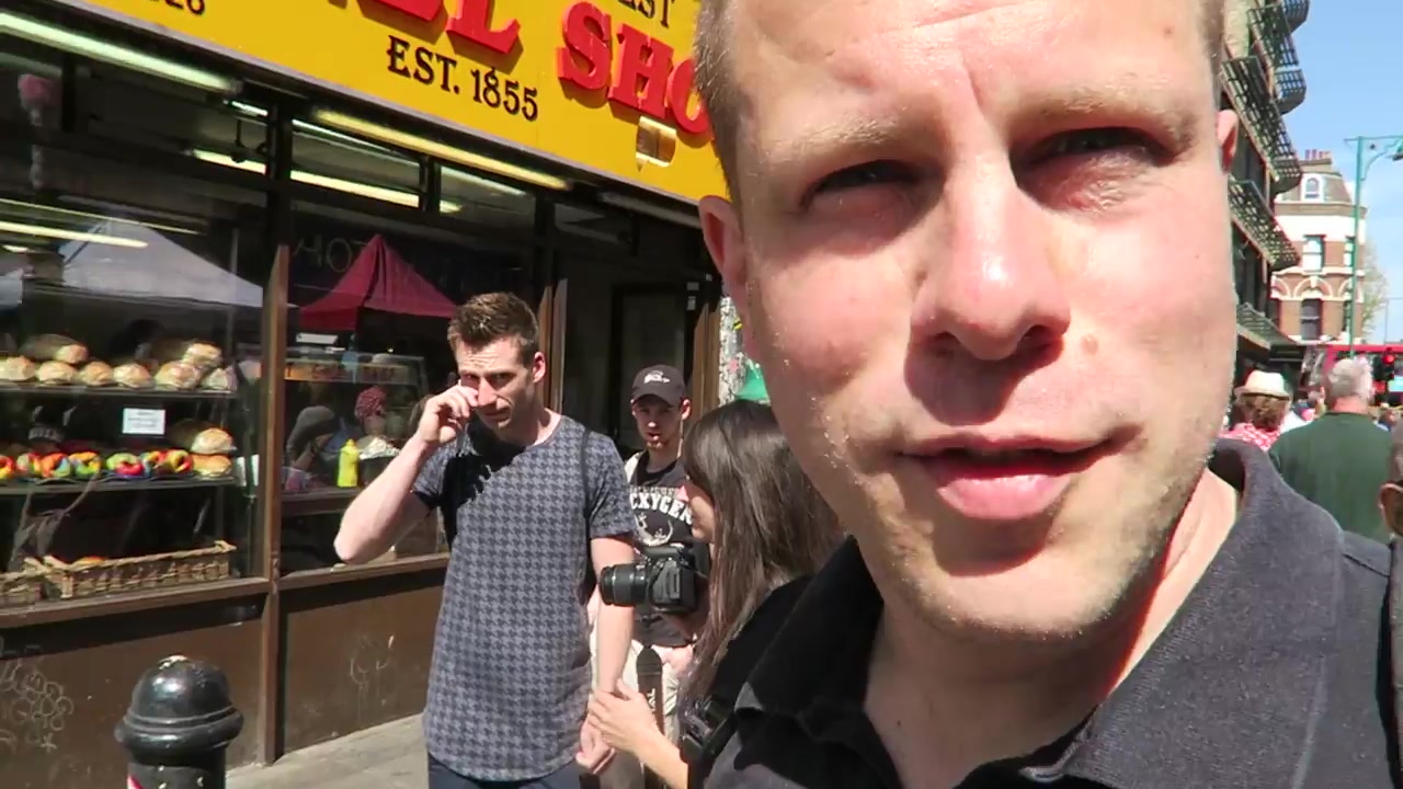 Barry outside the yellow-fronted Beigel Shop on Brick Lane