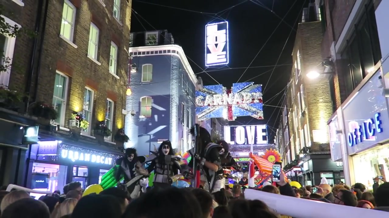 Carnaby and Love signs above colourful street performers in 2016