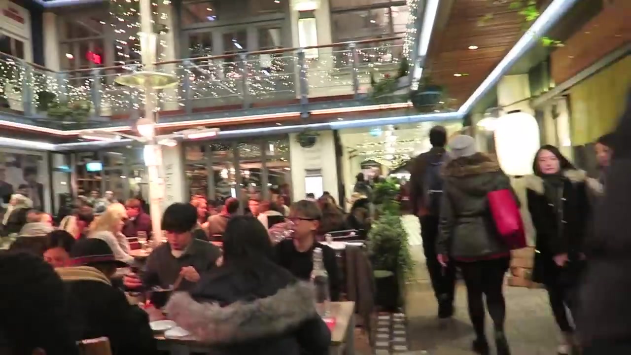 Diners and illuminated balconies in Kingly Court at night in 2016
