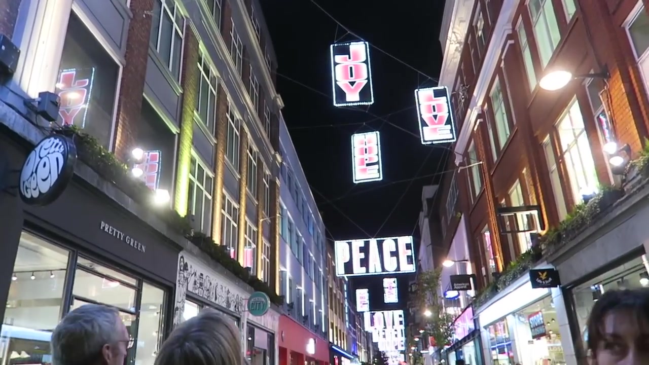 Illuminated Peace and Love signs above Carnaby Street in 2016