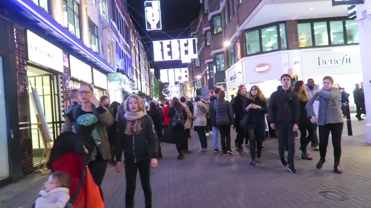 Evening shoppers beneath illuminated decorations on Carnaby Street