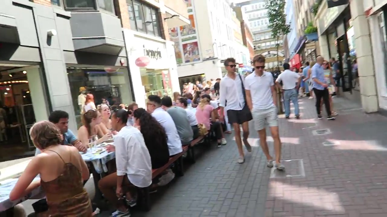 People eating at long tables along Carnaby Street