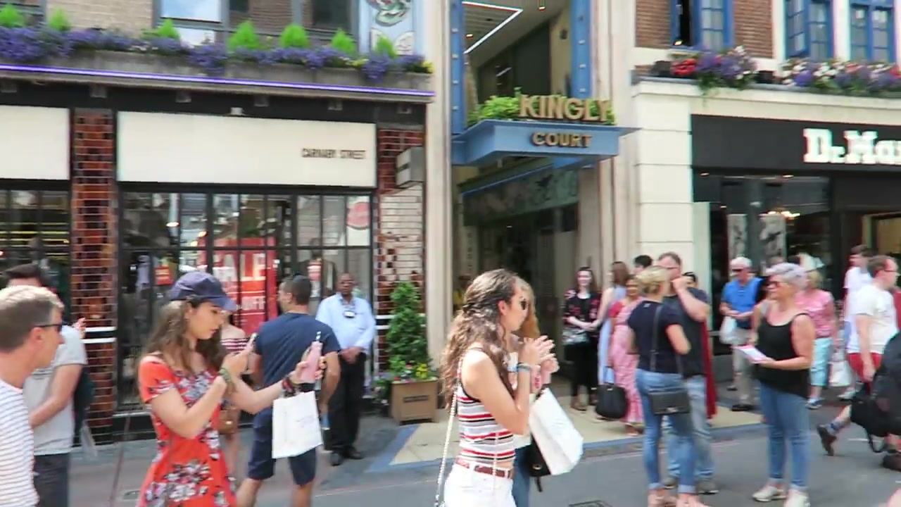 A crowd watching a performance near the Kingly Court entrance