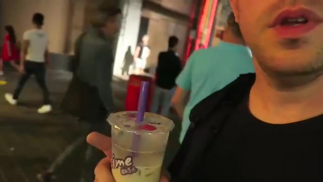 Barry holding a sealed Chatime bubble tea cup in Chinatown