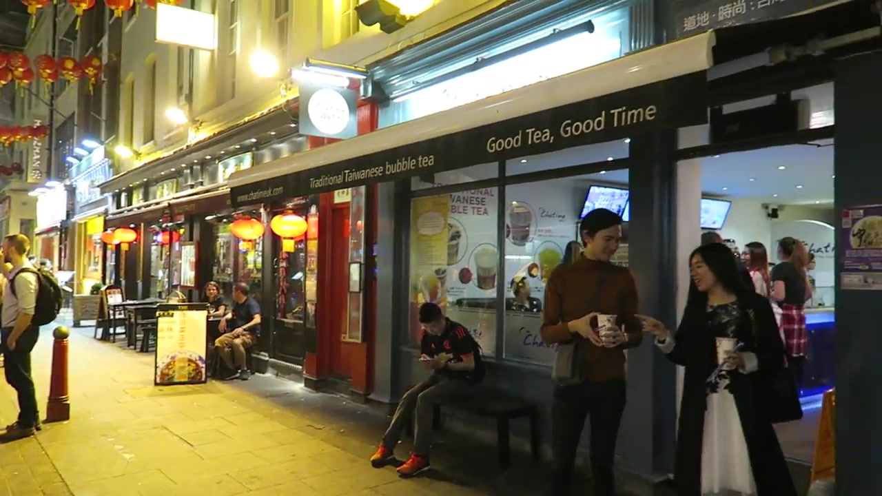 Chatime shopfront and customers in Chinatown at night