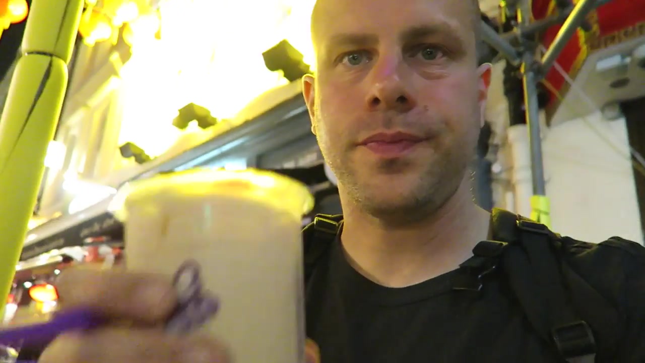 Barry holding a sealed cup of Chatime roasted milk tea
