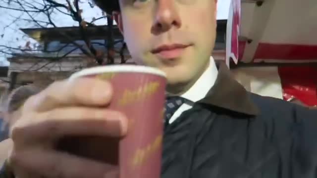 Barry holding a cup of mulled wine at Duke of York Square