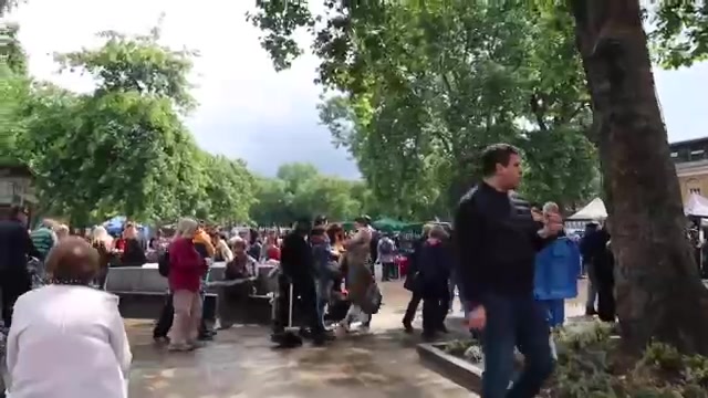 Visitors browsing stalls beneath trees at Duke of York Square