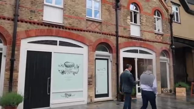 Food-shop windows beneath brick arches on Pavilion Road
