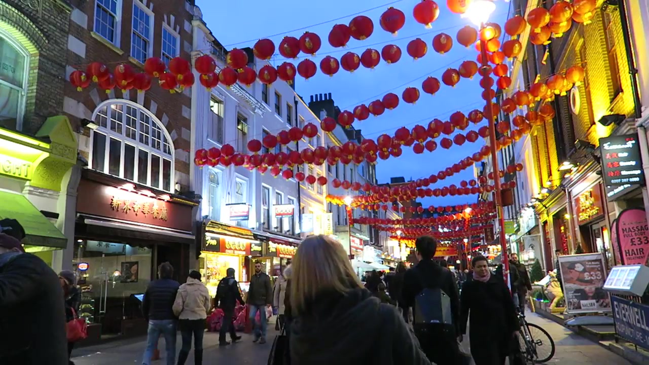 Red Chinese New Year lanterns above pedestrians in London Chinatown in 2016
