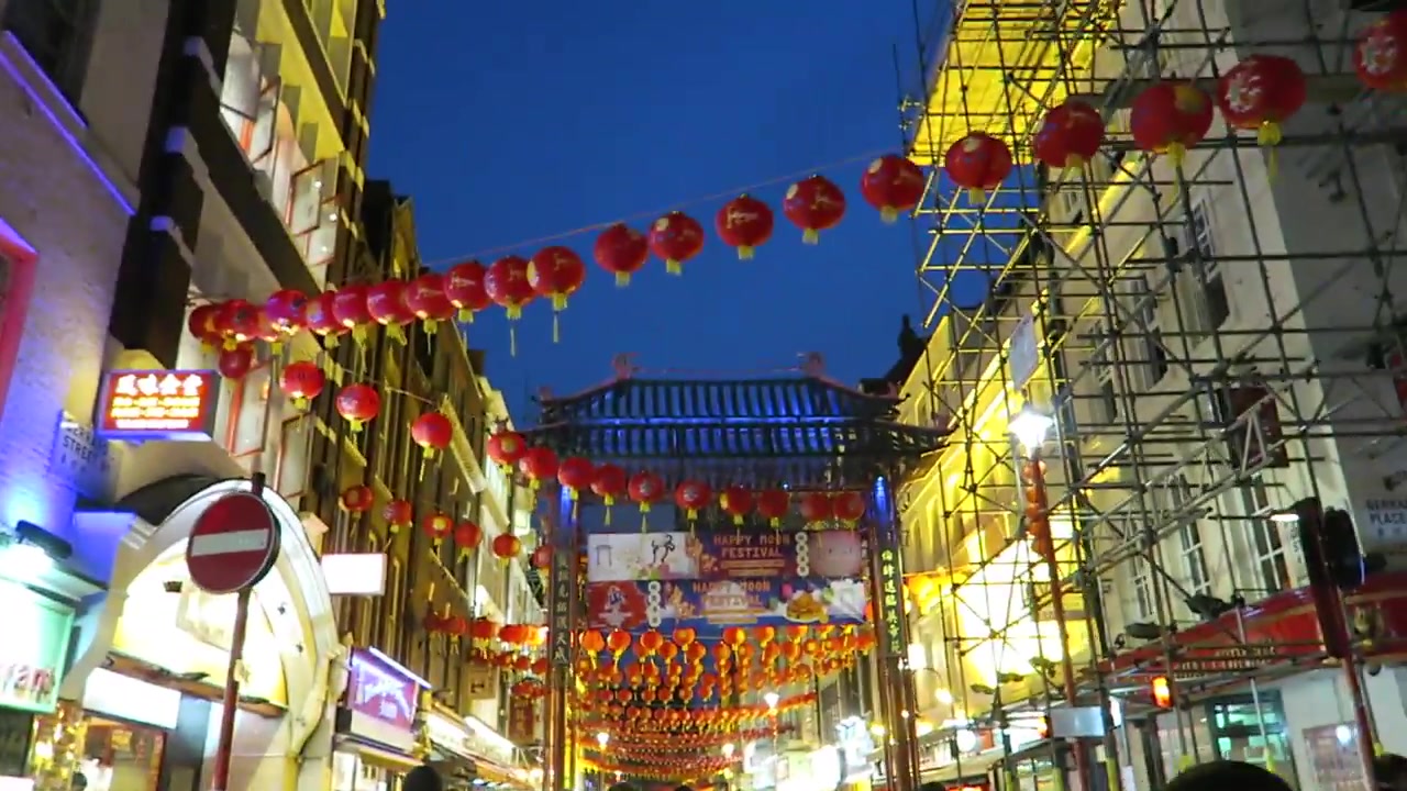Red lanterns above a Chinatown street and gateway at dusk in 2016