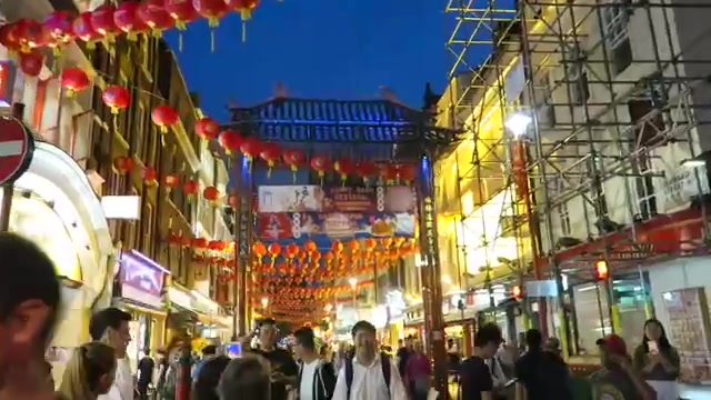 Red lanterns above a busy Chinatown street at dusk in September 2016