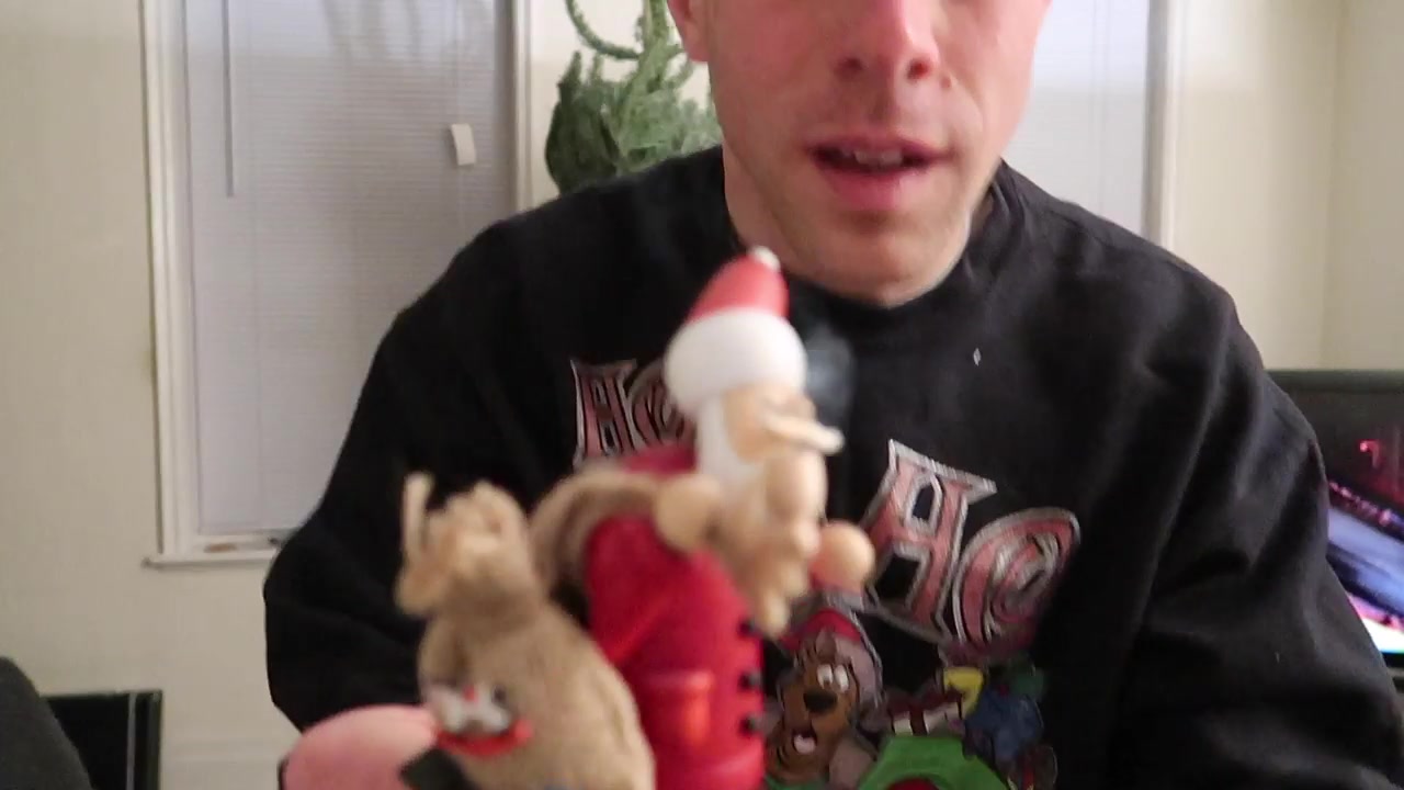 A smoking Santa ornament comes out of the Christmas decoration box.