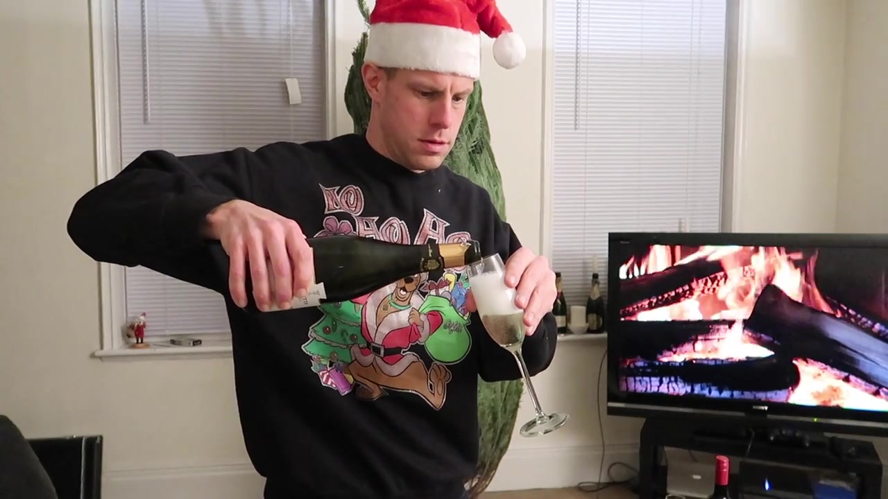 Pouring a festive glass of bubbles before decorating the tree.