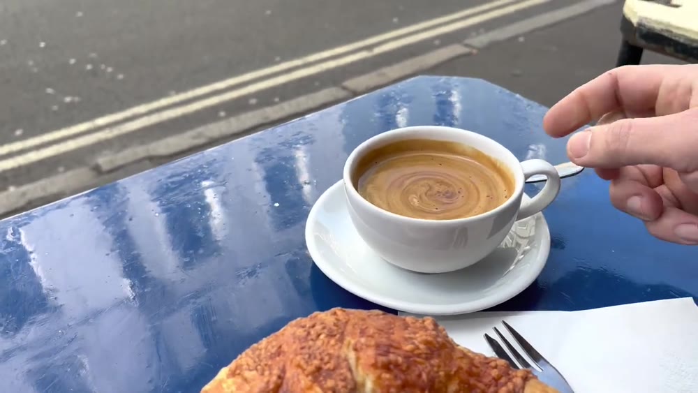 Coffee and a croissant served outside Maison Bertaux in Soho