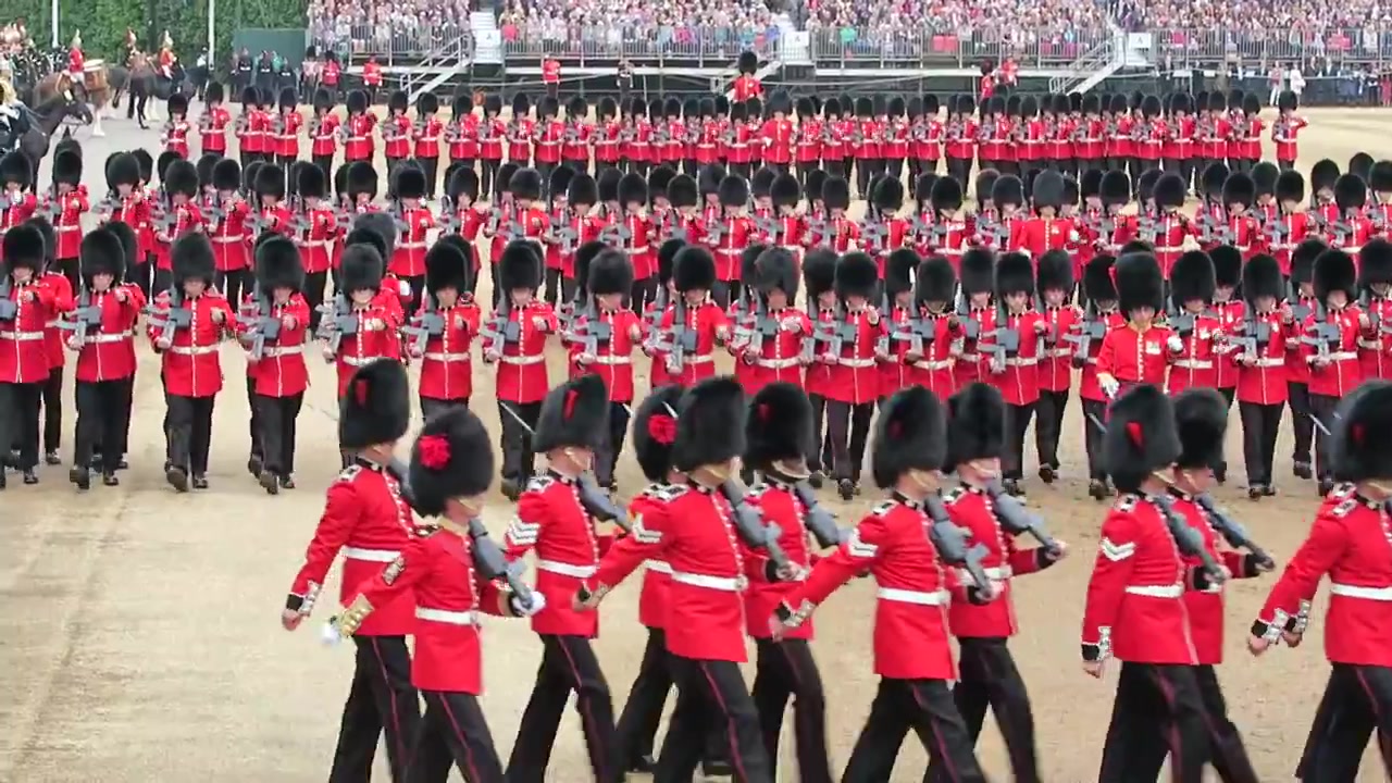 Military band in bearskin caps and scarlet tunics crossing the parade ground