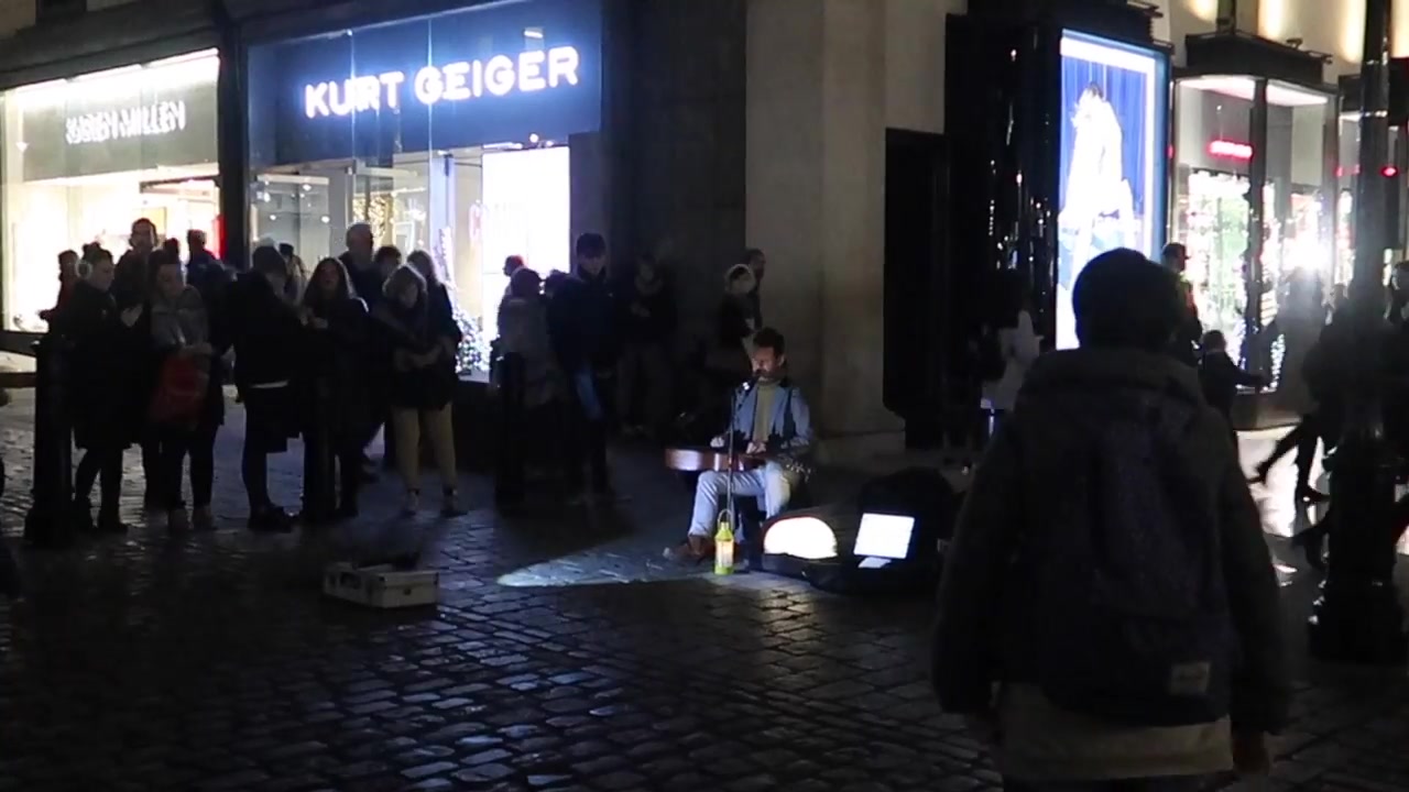 Guitarist Peter Leonard performing beside the market building.