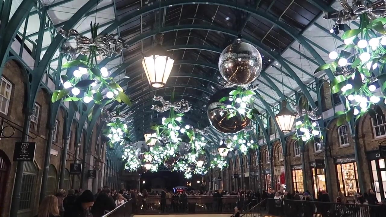 Mistletoe decorations and mirrored baubles beneath the market’s iron and glass roof.