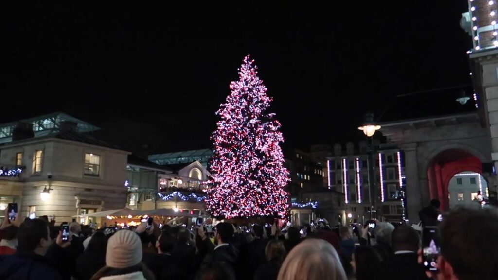 Illuminated Covent Garden Christmas tree above the Piazza crowd in 2018