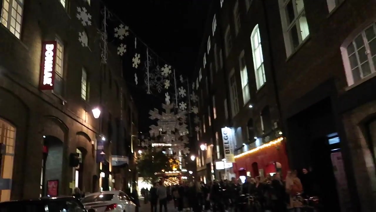 Christmas decorations suspended above a Covent Garden street at night