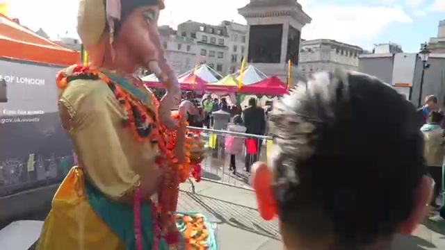 Decorated Ganesha figure beside festival stalls in Trafalgar Square