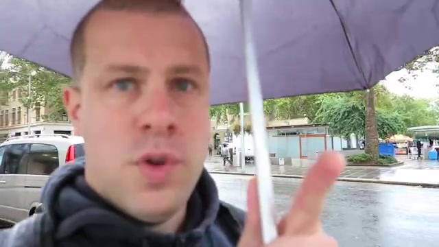 Barry with an umbrella beside Duke of York Square in Chelsea