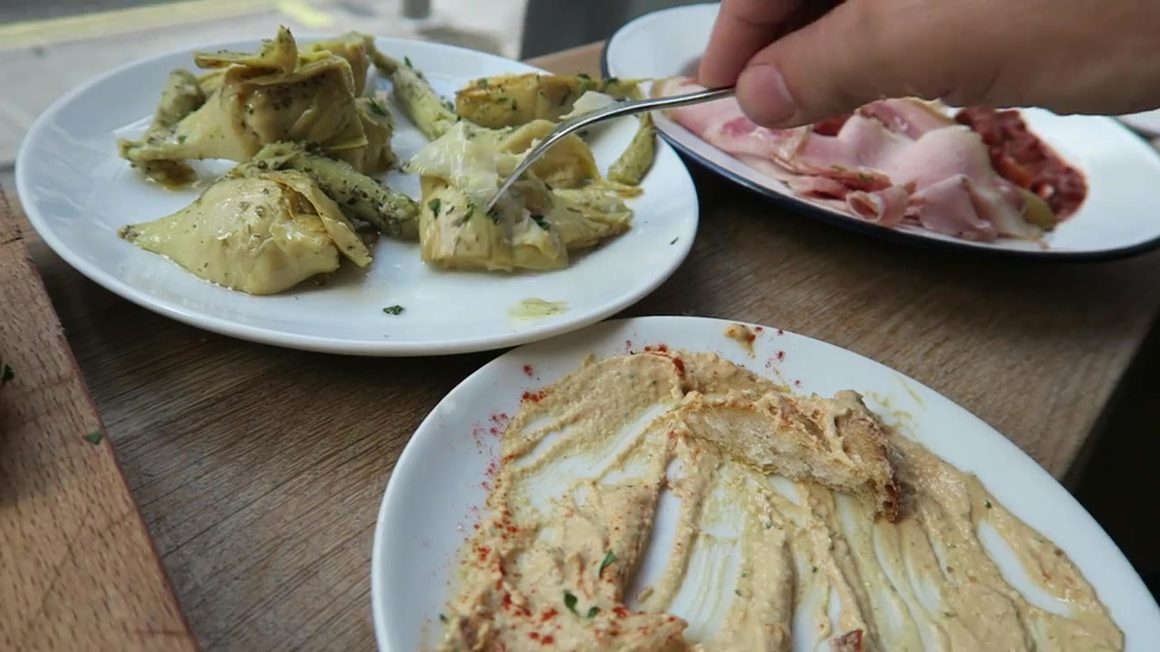 Grilled artichokes and hummus on the table at Fernandez and Wells