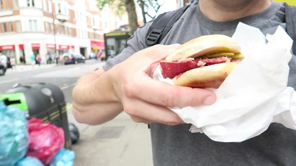 Salt beef bagel with pickles from Gaby’s Deli held in a paper wrapper