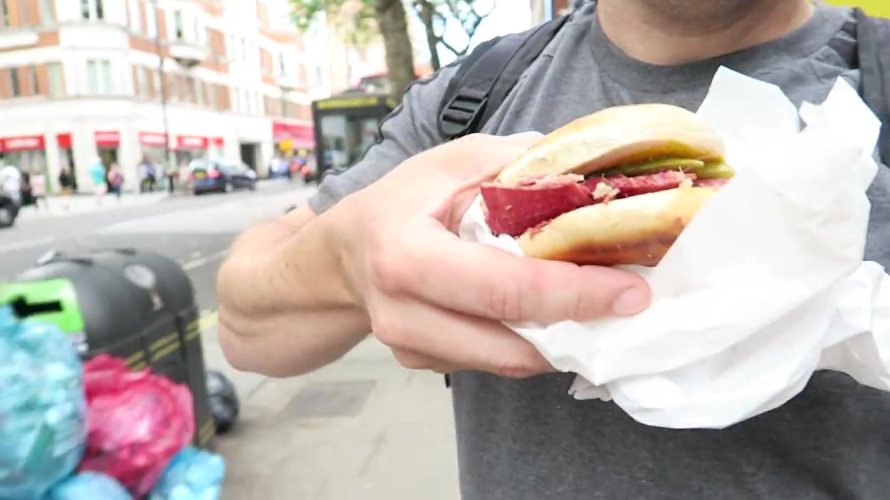 Salt beef bagel with pickles from Gaby’s Deli held in a paper wrapper