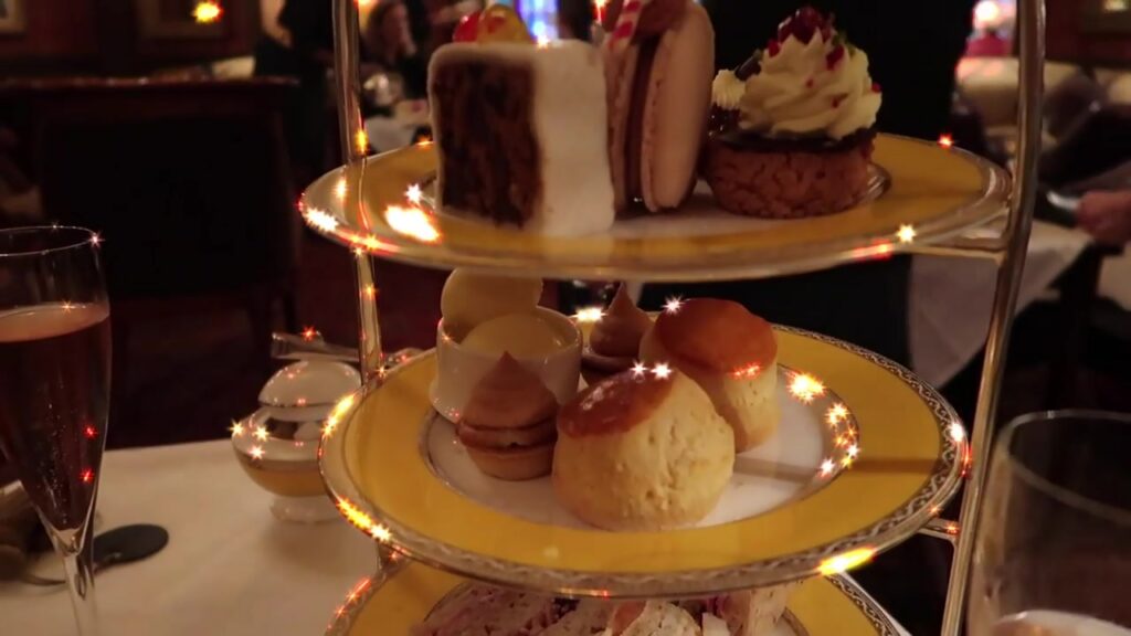 Cakes and sweet treats on the upper tier of the afternoon tea stand.