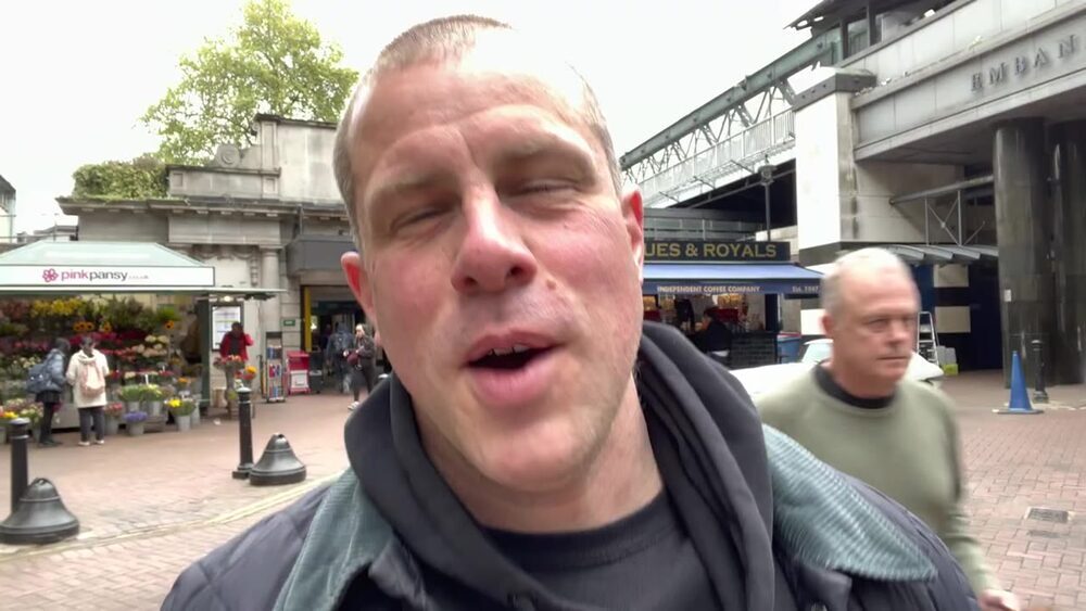 Barry Roberts walking outside Charing Cross Station in London
