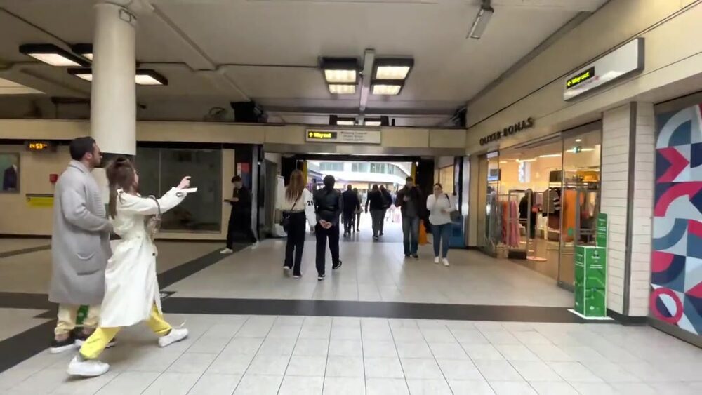 Passengers inside Charing Cross Station concourse in London