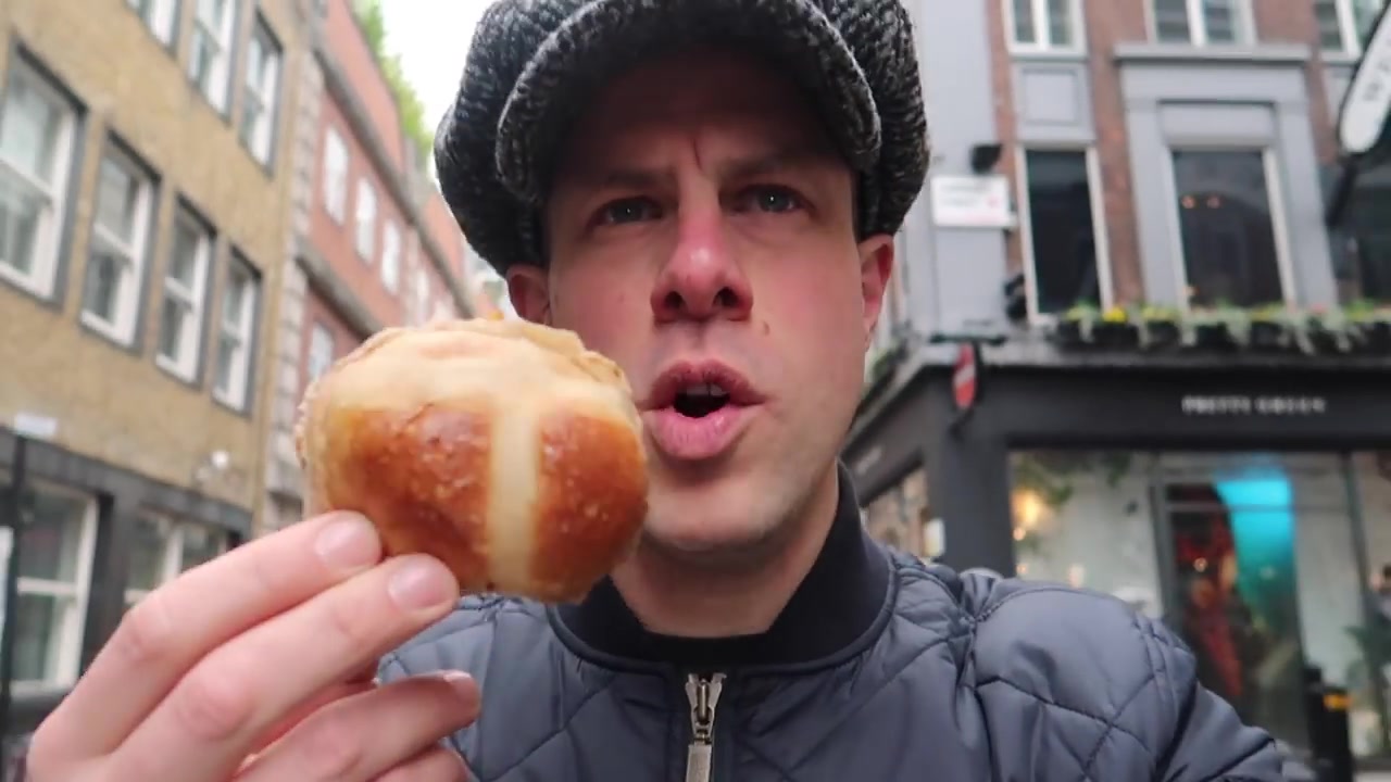 Barry holds up his hot cross bun before tasting it without butter.