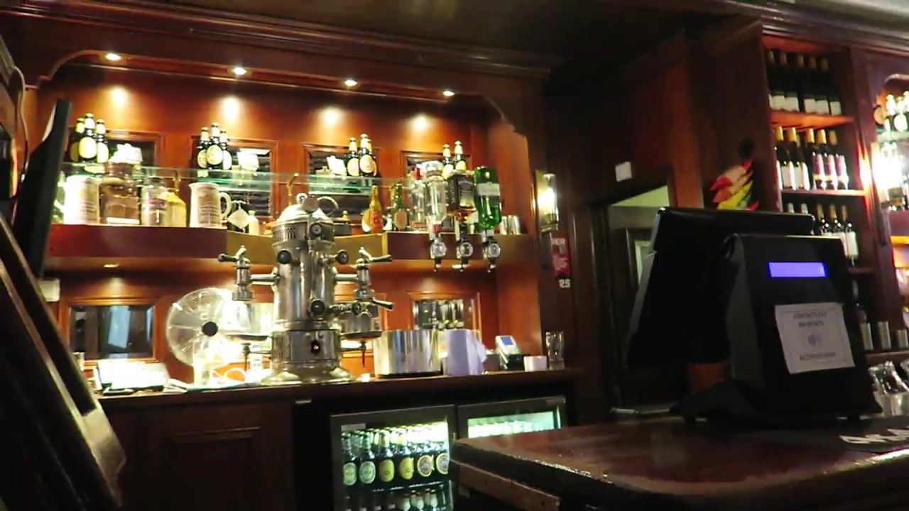 Polished coffee machine and bottles behind the wooden bar at Jamaica Wine House