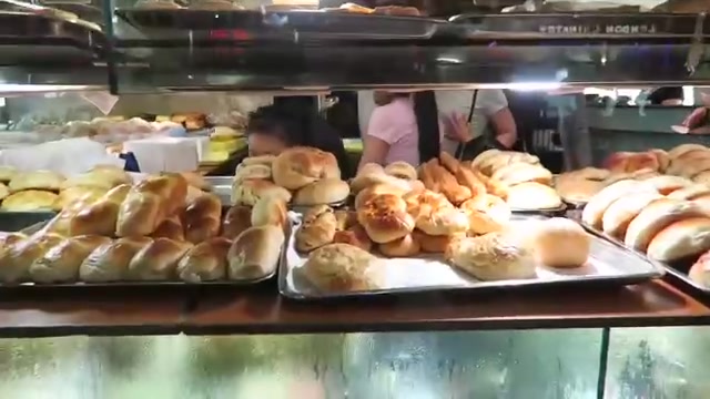 Pastries arranged on shelves behind the Kowloon bakery counter